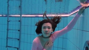 Long-legged girl goes swimming in her leotard
